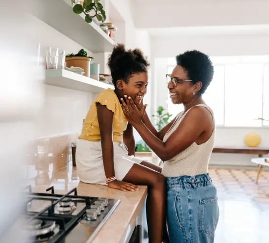 a mother and daughter in their kitchen