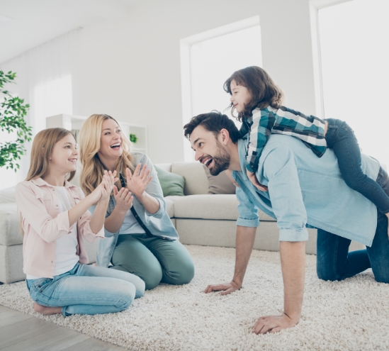 a mother and father play with their children